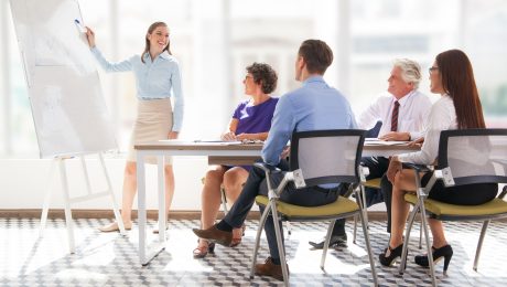 Cheerful business coach explaining strategy